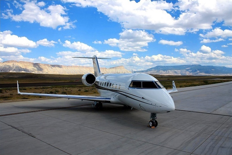 Challenger jet parked before an accessible private charter from Naples, Florida