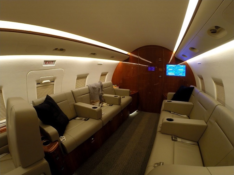 Private jet cabin with sofa and reclining seats for accessible travel from Naples, Florida