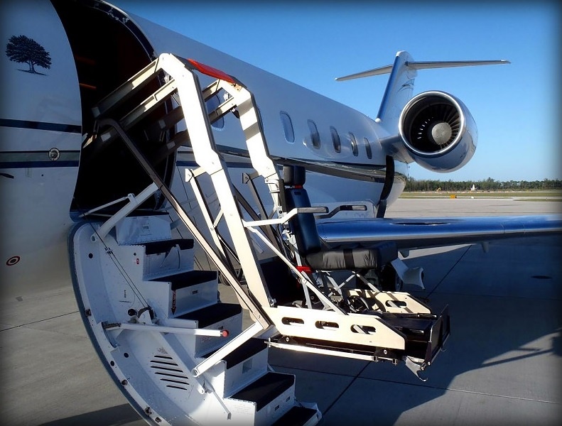 Wheelchair lift raised to the cabin door of a private jet in Naples, Florida